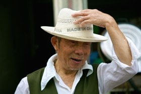 Unaware of what the words on his hat meant! South China.